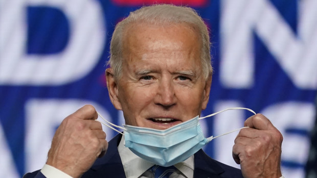 Joe Biden removes his face mask to speak at The Queen theater, Delaware, on November 5.