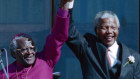 This photo from 1994 shows former  South African president Nelson Mandela, right, holding hands with former Bishop Desmond Tutu in Cape Town South Africa.