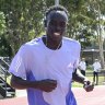 Australian runners Peter Bol and Gout Gout on the track together.