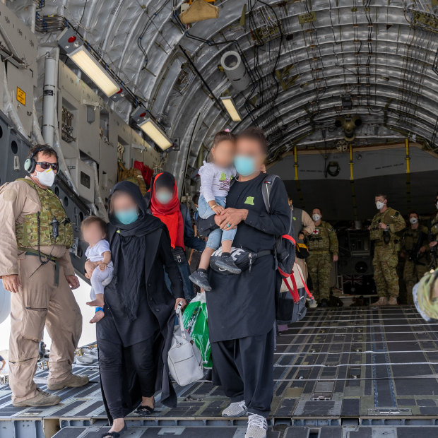 A family of evacuees from Afghanistan arrives at Australia’s main operating base in the Middle East on board a Royal Australian Air Force C-17A Globemaster in August 2021. 