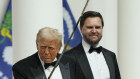 President Donald Trump holds a sabre after using it to cut a cake, at the Commander in Chief Ball.