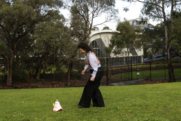 Dani Valent takes delivery of the takeaway order in a park, and the drone’s tether is retracted.