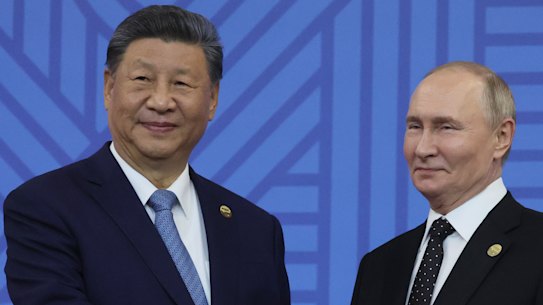 Chinese President Xi Jinping and Russian President Vladimir Putin shake hands during a welcoming ceremony prior to a festive reception at BRICS Summit in Kazan, Russia, on Wednesday.