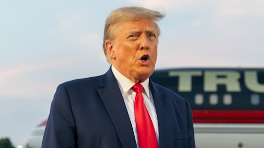 FILE - Former President Donald Trump speaks with reporters before departure from Hartsfield-Jackson Atlanta International Airport, Thursday, Aug. 24, 2023, in Atlanta. Trump has pleaded not guilty and waived arraignment in the case accusing him and others of illegally trying to overturn the results of the 2020 election in Georgia. (AP Photo/Alex Brandon, File)