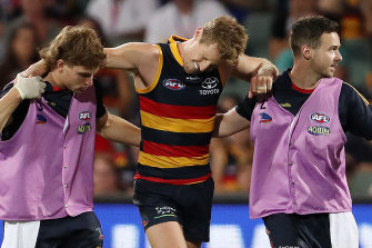 Rory Sloane winces in pain as he leaves the field injured. 
