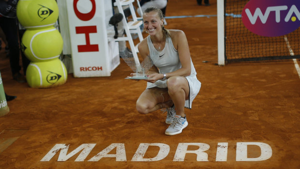 Czech Republic's Petra Kvitova poses with her trophy after winning against The Netherlands' Kiki Bertens in the Madrid Open.