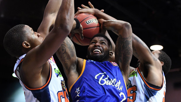 Alonzo Gee of the Bullets (centre) is blocked by Taipans defence during the round 1 NBL match between the Bullets and Cairns Taipans at the Brisbane Convention and Exhibition Centre on Saturday.