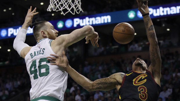Boston's Aron Baynes blocks a shot from Cleveland's George Hill.