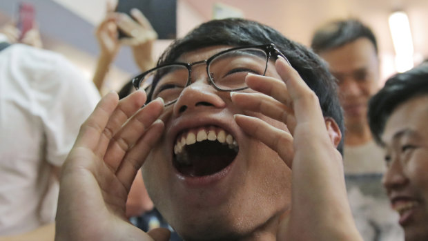Pro-democracy supporters celebrate after pro-Beijing politician Junius Ho lost his election in Hong Kong.