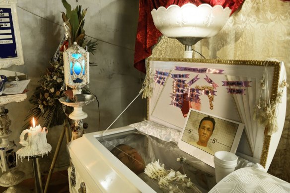 The body of Ramil Miranda,35, lies in his coffin at his wake in the Manila suburb of Malabon. The known drug user was a victim of an extra judicial killing in 2017. 
