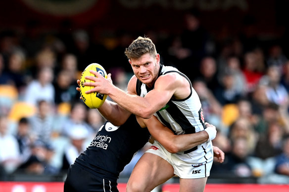 Taylor Adams tries to break a tackle in Collingwood’s 127th win over Carlton.