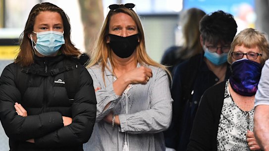 People wear masks on the streets in Melbourne.