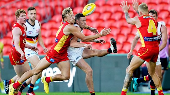 Hugh Greenwood of the Suns tackles Rory Laird of the Crows  during the Round 3 AFL match between the Gold Coast Suns and the Adelaide Crows at Metricon Stadium on the Gold Coast, Sunday, June 21, 2020. (AAP Image/Dave Hunt) NO ARCHIVING, EDITORIAL USE ONLY
