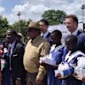 Lindian Resources executive chairman Robert Martin, executive director Zac Komur and the Hon. Bright Msaka SC with students of the Kangankunde Primary School and members of the local community.