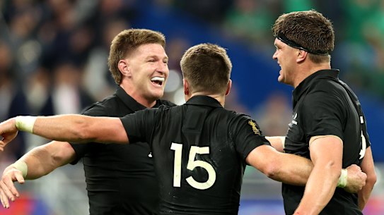 Brothers Jordie Barrett, Beauden Barrett and Scott Barrett celebrate after the win.