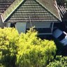 Driver freed after car wedges between house and wall at Albany Creek