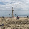 'The smell of dead bodies is overwhelming': Volunteers comb through beachfront in Palu