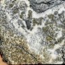 Core from Strickland Metals’ Kotlovi prospect showing skarn-hosted gold mineralisation with disseminated pyrite and carbonate veins from 349.4 metres downhole and assaying 4.4g/t gold.