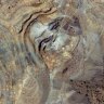An overhead picture of Dateline Mining’s Colosseum mine in California, showing the recent drill orientation in the North Pit and the water-filled South Pit.