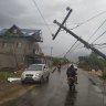 A man rides his motorbike trough a road damaged by heavy winds of Hurricane Iota in Puerto Cabezas, Nicaragua . 