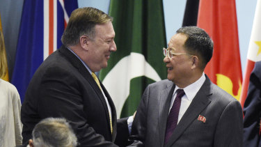 US Secretary of State Mike Pompeo, left, greets North Korea's Foreign Minister Ri Yong-ho at the 25th ASEAN Regional Forum Retreat in Singapore on Saturday.
