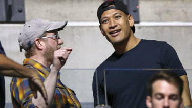 Support crew: Israel Folau was among the spectators as wife Maria took the court against Australia.