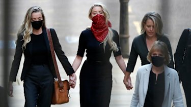 Amber Heard, centre, arrives at the High Court in London.