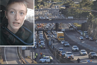 A protester used a bike lock to attach herself to a car blocking the entrance to the Sydney Harbour Tunnel.