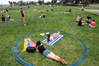 Beachgoers sat in 'social distancing circles' drawn by the council.
