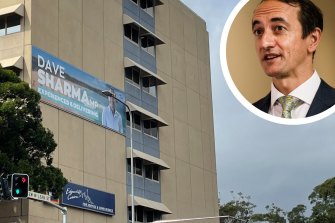 Dave Sharma’s billboard is in breach of the building’s development application, but is likely to remain in place until after the election.