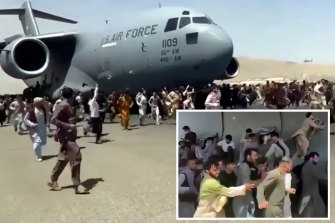 Hundreds of people run alongside a US Air Force C-17 transport plane at Kabul airport on Monday.