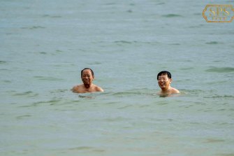 Cambodian Defence Minister Tea Banh and Chinese ambassador Wang Wentian swim at the beach near the Ream Naval Base, Sihanoukville, Cambodia, on June 7. 