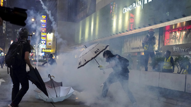 Protesters react to tear gas during a confrontation with police.