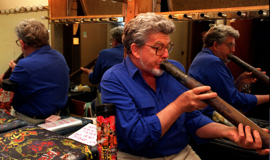 Rolf Harris with didgeridoo prepares to go on stage at St George Leagues Club in 1996.
