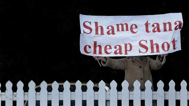 View from the gallery: A woman holds up a banner chastising  then All Blacks captain Tana Umaga for his tackle on Lions captain Brian O'Driscoll during a public training session at The Basin Reserve.