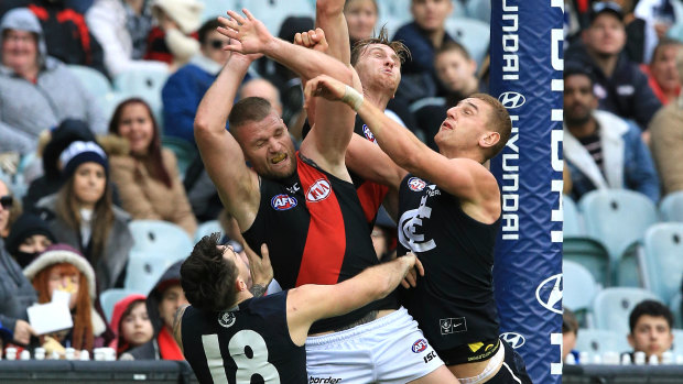 Strung out: Essendon's Jake Stringer gets swamped by Carlton defenders in the goalsquare during a marking attempt.