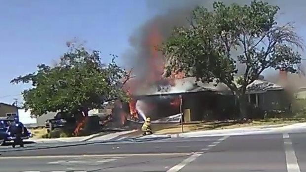 A firefighter works to extinguish a fire following an earthquake in Ridgecrest, California.