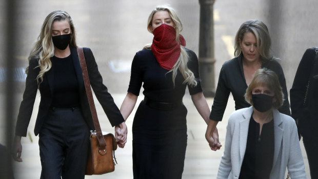 Amber Heard, centre, arrives at the High Court in London.