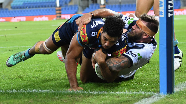Denied: Kyle Feldt of the Cowboys makes a try saving tackle on Brian Kelly.