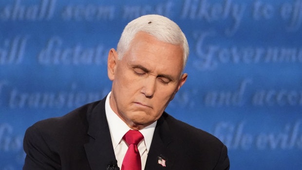 Vice-President Mike Pence listens to Democratic rival Kamala Harris during the debate on Wednesday night.
