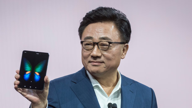 Samsung's president of mobile communications DJ Koh with the original Galaxy Fold in February. 