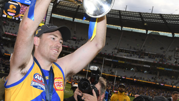 Jeremy McGovern of the Eagles holds the premiership trophy.