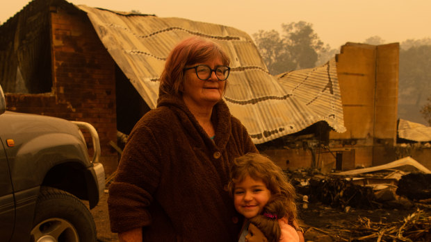 It is up to adults to give children a sense of hope: Barbara Rugendyke, pictured with one of her children in front of their property, which was devastated by bushfires.