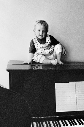 Musical family: A young Martha Marlow atop a piano.