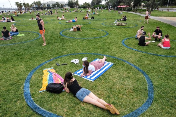 Beachgoers sat in 'social distancing circles' drawn by the council.