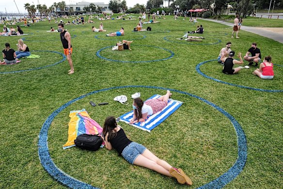 Beachgoers sat in 'social distancing circles' drawn by the council.