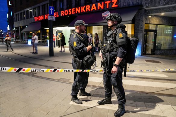 Security forces stand outside the London Pub, in central Oslo, Norway. 