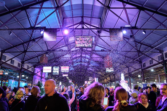 Faux snow falls at the Queen Victoria Market’s winter night market.