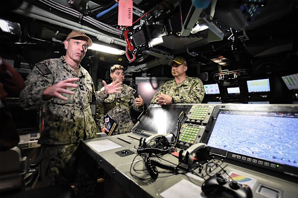 Rear Admiral Lincoln Reifsteck, left, speaks to media during a tour of the USS Vermont. 
