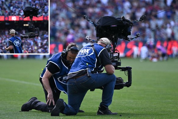 Fox Sports camera operators inspect the spider cam they were using at the MCG.